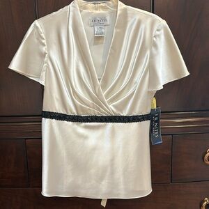 Ivory and black stretch satin top with black beads tucked under bust. Size 10